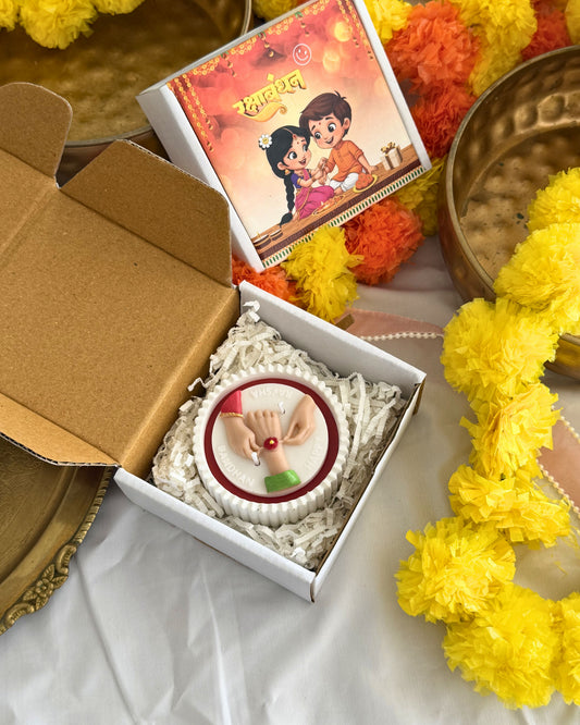 Rakhi candle in white concrete bowl